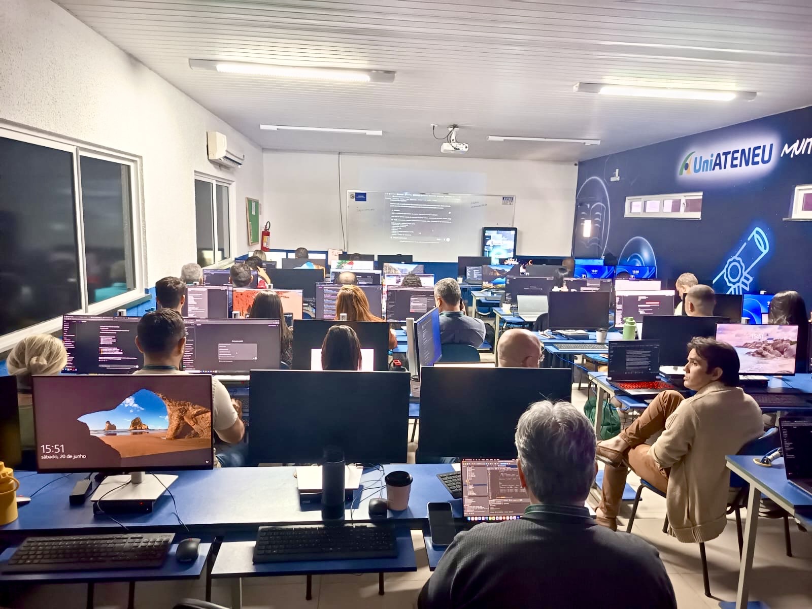 Sala de aula cheia com participantes nos computadores durante a Imersão ChatGPT